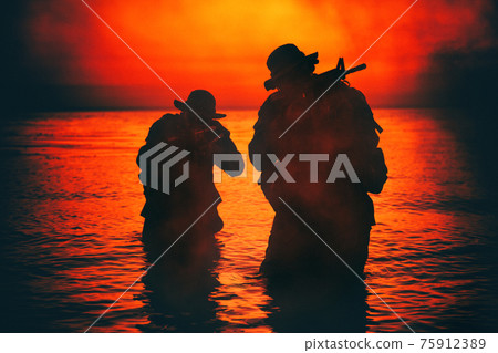 Commando soldiers walking in water and aiming gun Commando soldiers walking in water and aiming gun 75912389