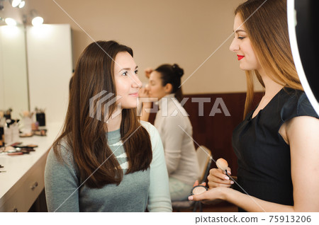 Make up artist doing professional make up of young woman. Beauty shcool. Make up artist doing professional make up of young woman. Beauty shcool. 75913206