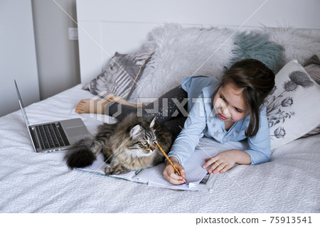 Distance learning online education. Schoolgirl with digital tablet laptop notebook and doing school 75913541