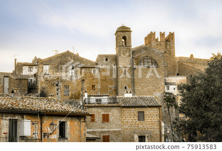 View of medieval towers and walls of the commune town of Calcata in Italy 75913583