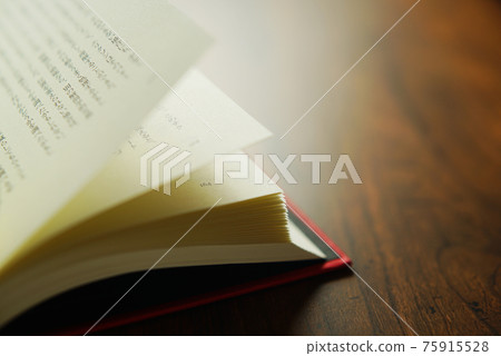 Turn over a book on a bright background. Turn over a book on a bright background. 75915528