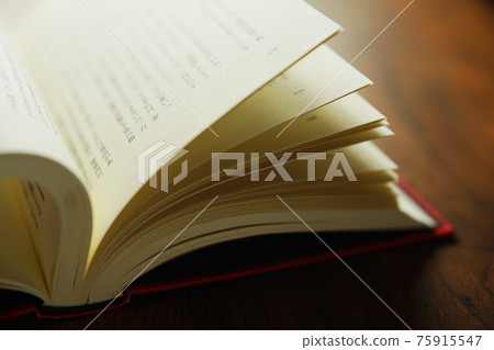 Turn a book on a bright background 75915547