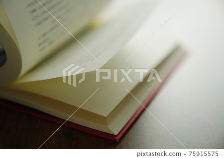 Turn a book on a bright background 75915575