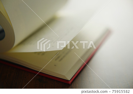 Turn a book on a bright background 75915582