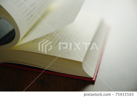 Turn a book on a bright background 75915583