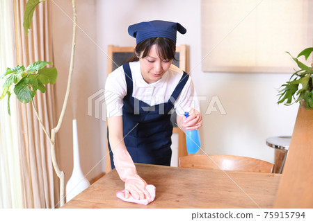 Housekeeper woman wiping the table Housekeeper woman wiping the table 75915794