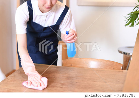 Housekeeper woman wiping the table Housekeeper woman wiping the table 75915795