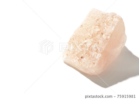 Photographed a mass of pink rock salt on a white background Photographed a mass of pink rock salt on a white background 75915981