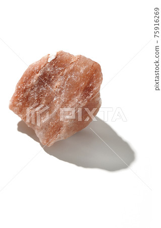 Photographed a mass of red rock salt on a white background Photographed a mass of red rock salt on a white background 75916269