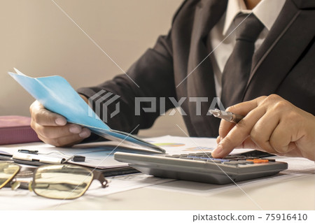 Business people or accountants who are reviewing financial documents and account books, work and financial ideas. Business people or accountants who are reviewing financial documents and account books, work and financial ideas. 75916410