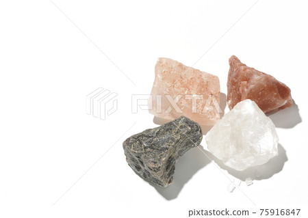 Shooting rock salt lumps of various colors on a white background Shooting rock salt lumps of various colors on a white background 75916847