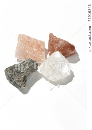 Shooting rock salt lumps of various colors on a white background Shooting rock salt lumps of various colors on a white background 75916848