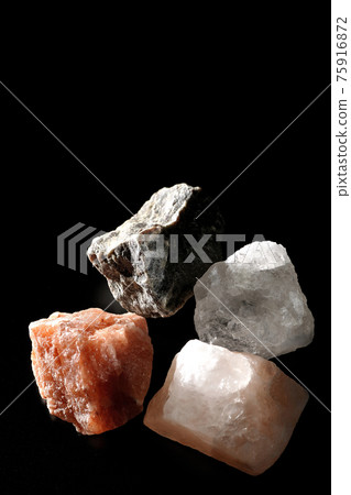 Shooting rock salt lumps of various colors on a black background Shooting rock salt lumps of various colors on a black background 75916872