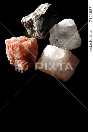 Shooting rock salt lumps of various colors on a black background Shooting rock salt lumps of various colors on a black background 75916874