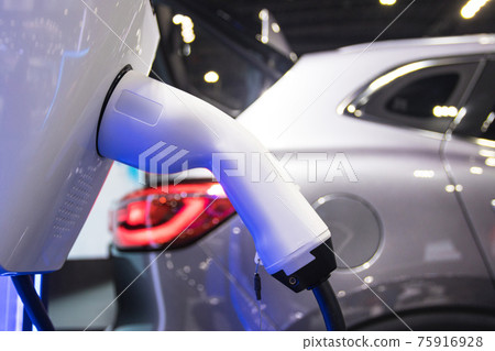 the charging the battery for the car new Automotive Innovations the power supply plugged into an electric car being charged, concept of energy innovation. 75916928