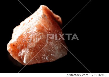 Photographed a mass of red rock salt on a black background Photographed a mass of red rock salt on a black background 75916960