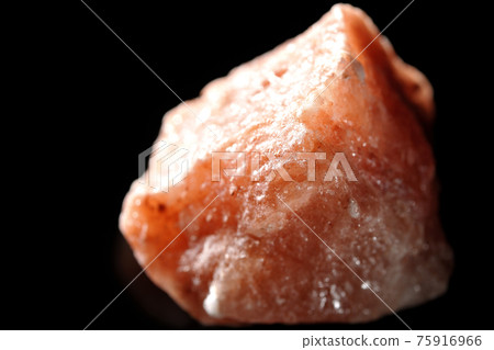 Photographed a mass of red rock salt on a black background Photographed a mass of red rock salt on a black background 75916966