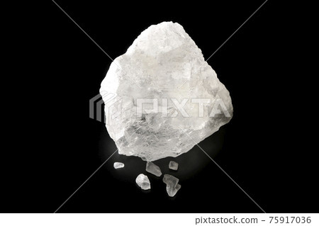 Photographed a block of rock salt that is as clear as crystal on a black background 75917036