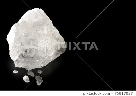 Photographed a block of rock salt that is as clear as crystal on a black background 75917037