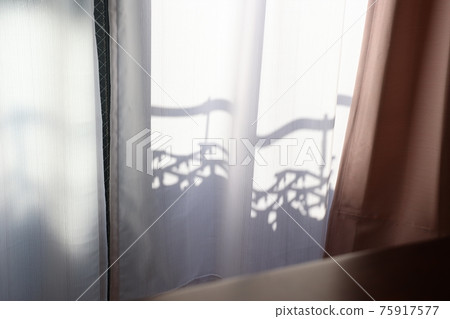 Laundry over the curtain on a sunny day Laundry over the curtain on a sunny day 75917577