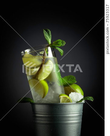 Mojito cocktail with ice, lime, and mint in a bucket with ice. Mojito cocktail with ice, lime, and mint in a bucket with ice. 75923317