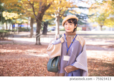 A named woman in an autumn park 75923413