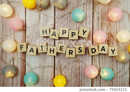 Happy Fathers day alphabet letter with LED cotton balls decoration on wooden background Happy Fathers day alphabet letter with LED cotton balls decoration on wooden background 75924215