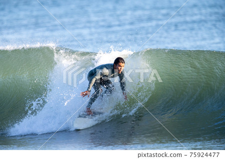 A man surfing in the Shonan sea 75924477