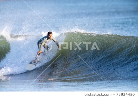 A man surfing in the Shonan sea 75924480