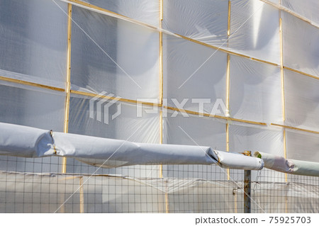 The construction site is fenced with a fence and a protective grid 75925703