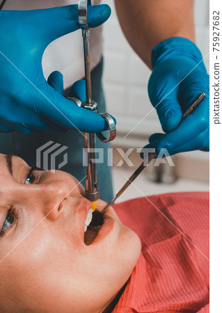 Local anesthesia, anesthesia, injection with a carpule syringe, the dentist injects the patient. 75927682