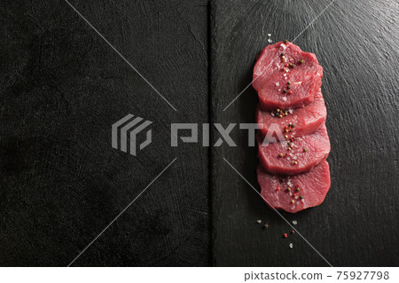 Raw Beef Medallions on a kitchen cutting board. Raw Beef Medallions on a kitchen cutting board. 75927798