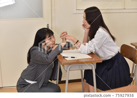 Female teacher and female student flirting in an empty classroom 1 75927938