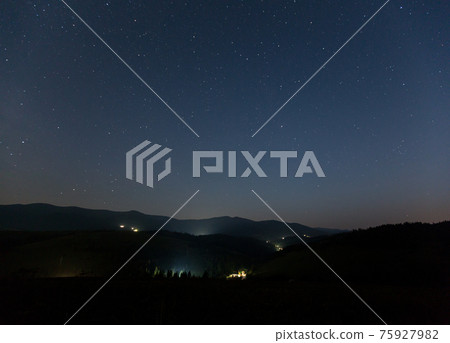 Starry sky over the mountains and mountain village. Starry sky over the mountains and mountain village. 75927982