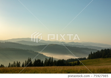 Beautiful early morning with fog between mountains Beautiful early morning with fog between mountains 75927985
