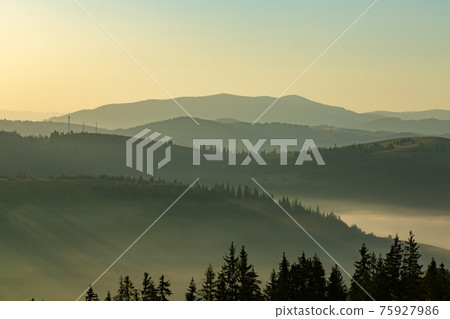Beautiful early morning with fog between mountains Beautiful early morning with fog between mountains 75927986