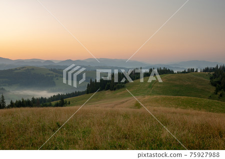 Beautiful early morning with fog between mountains Beautiful early morning with fog between mountains 75927988