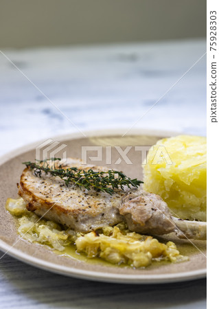 pork chop with thyme baked on creamy onion with mashed potatoes 75928303