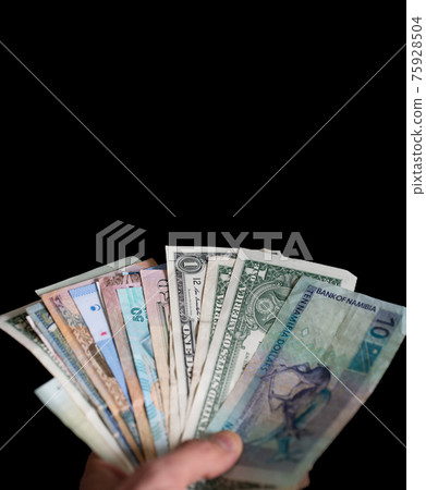 Hand holding different kind of bills over black 75928504