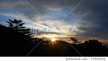 Huangshan Mountain in Anhui Province, China. Sunset over Huangshan with colorful sky and clouds and a silhouette of the mountain and trees. Sunset near the summit of Huangshan Mountain, China. Huangshan Mountain in Anhui Province, China. Sunset over Huangshan with colorful sky and clouds and a silhouette of the mountain and trees. Sunset near the summit of Huangshan Mountain, China. 75930356