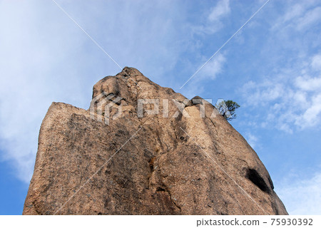 Huangshan Mountain in Anhui Province, China. Close up view of the top of Flying-Over Rock or Feilai Stone. This is one of the most famous sights on Huangshan Mountain, China. 75930392