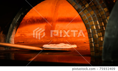 Close-up shot of hand made traditional italian pizza in wood fire oven 75931409