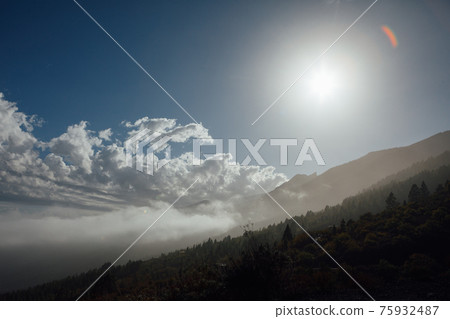 clouds on blue sky with sunshine in mountains clouds on blue sky with sunshine in mountains 75932487