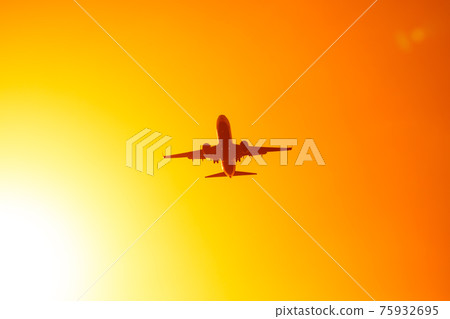 flying airplane in the orange sky sunset flying airplane in the orange sky sunset 75932695