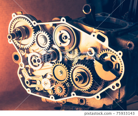 disassembled engine of motorcycle with gear cogwheels disassembled engine of motorcycle with gear cogwheels 75933143