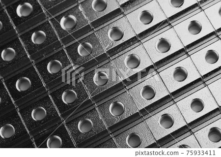 slide screw nuts in a row, abstract industrial background slide screw nuts in a row, abstract industrial background 75933411