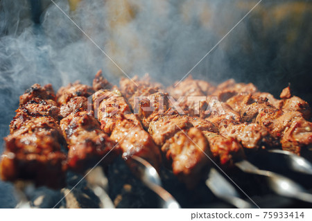 grilled barbecue meat on skewers with smoke grilled barbecue meat on skewers with smoke 75933414