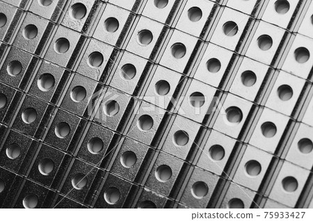 slide screw nuts in a row, abstract industrial background slide screw nuts in a row, abstract industrial background 75933427