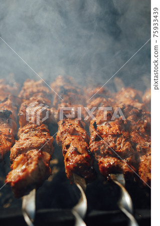 grilled barbecue meat on skewers with smoke grilled barbecue meat on skewers with smoke 75933439