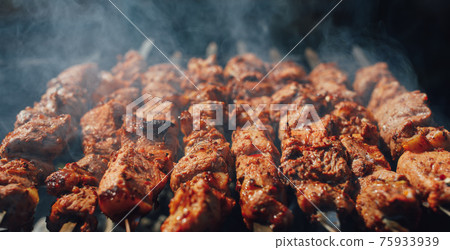 grilled barbecue meat on skewers with smoke grilled barbecue meat on skewers with smoke 75933939